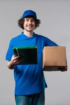 Smiling Postal Courier in blue uniform, Porter Man With Parcel Box. Happy H.. Stock Photos