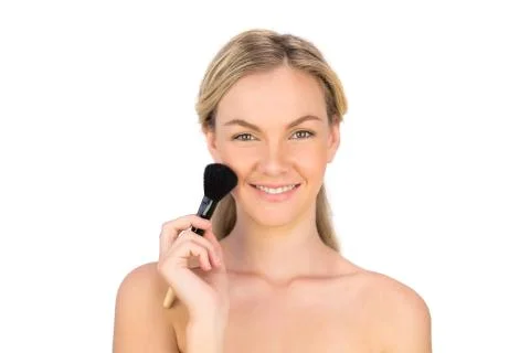 Smiling pretty bare blonde using powder brush Stock Photos
