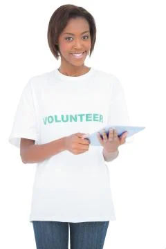 Smiling pretty volunteer using tablet pc Stock Photos