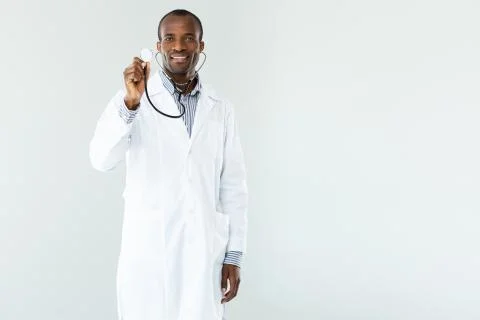 Smiling professioanl doc using his stethoscope Stock Photos