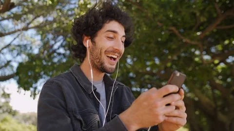 Smiling profile of a young man calling via video call on phone talking to Stock Footage 123413811