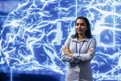 Smiling programmer working with AI machine learning algorithms in workspace 写真素材