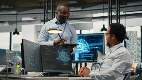 Smiling programmers working in AI startup train predictive models Video stock 323238653