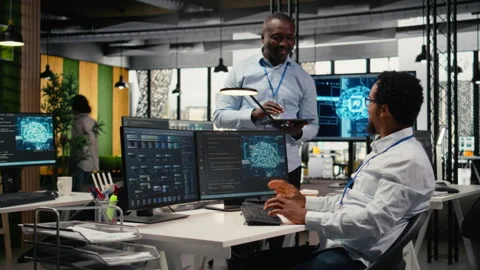 Smiling programmers working in AI startup train predictive models Stock Footage 323239486