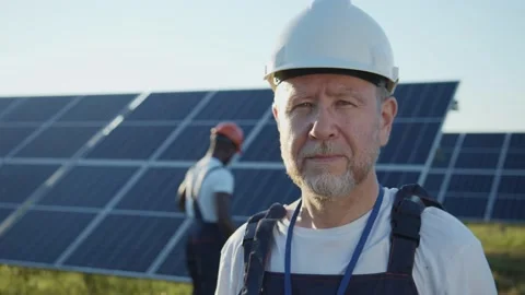 Smiling proud caucasian engineer standing by solar panel installation Stock Footage 135525585