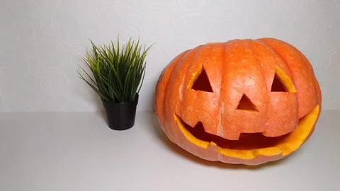 Smiling pumpkin on a light background close-up Stock Photos