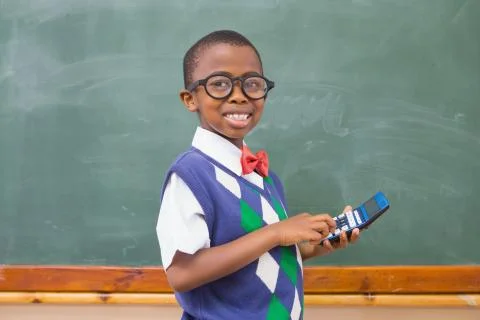 Smiling pupil using calculator Foto stock