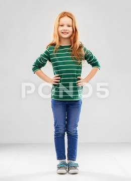 Smiling red haired girl posing in striped shirt Stock Photos