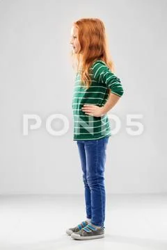 Smiling red haired girl posing in striped shirt Stock Photos