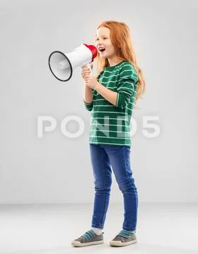 Smiling red haired girl speaking to megaphone Stock Photos