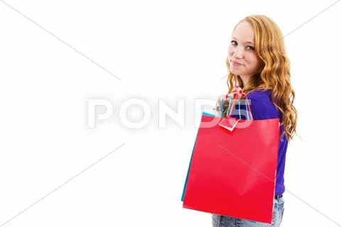 Smiling redhead woman with shopping bags Stock Photos