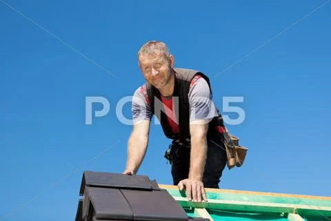 Smiling roofer on top of the roof Stock Image ~ #25619776