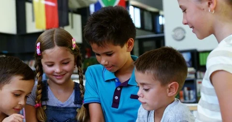 Smiling school kids using digital tablet in classroom Stock Footage 78705679