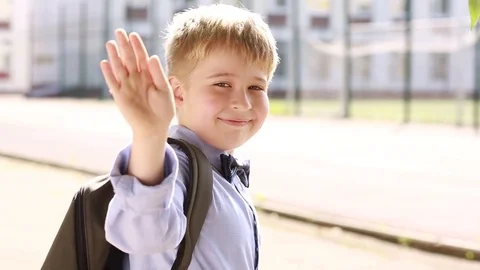 A smiling schoolboy waving good-bye and running to school. Stock Footage 79168204