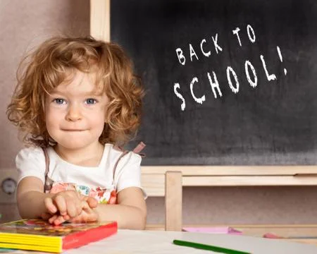 Smiling schoolchild in a class Stock Photos