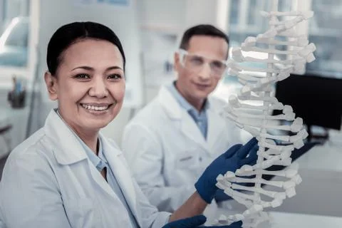 Smiling scientist trying to decode DNA secrets Stock Photos