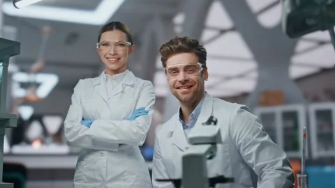 Smiling scientists looking camera in modern laboratory close up. Two researchers Stock Footage 254619728