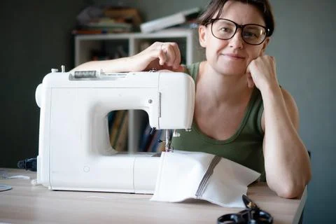 Smiling seamstress looking at camera in workshop Stock-Fotos