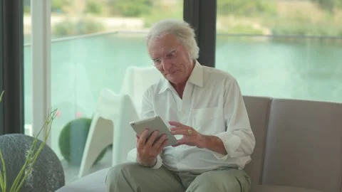 Smiling senior elder 80s man using digital tablet computer pad modern tech relax Stock Footage 155169262