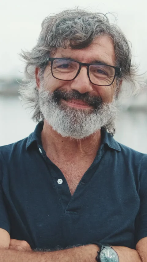 Smiling senior man crossing his arms and looking at the camera on yacht Stock Footage 250842007