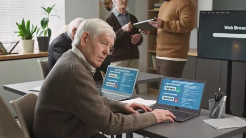 Smiling Senior Man at Desk in Computer Literacy Class for Seniors Stock Footage 333758368