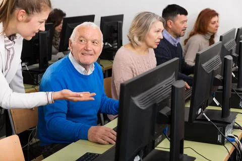 Smiling senior man during computer classes Fotos de archivo