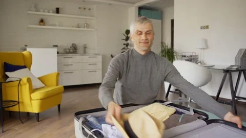 Smiling senior man preparing for vacations Stock Footage 133494073