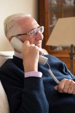 Smiling Senior Man Using Phone At Home Stock Photos
