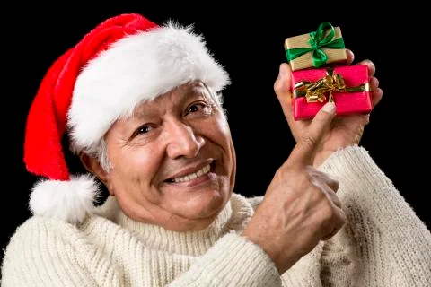Smiling senior pointing at two wrapped xmas gifts Stock Photos