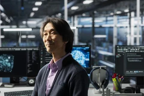 Smiling senior programmer in data center working on AI databases Stock Photos