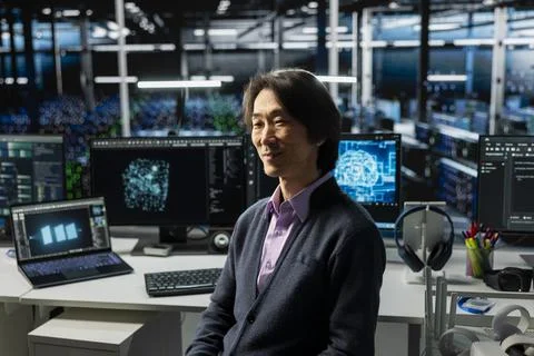 Smiling server hub senior programmer using devices to monitor neural networks 스톡 사진