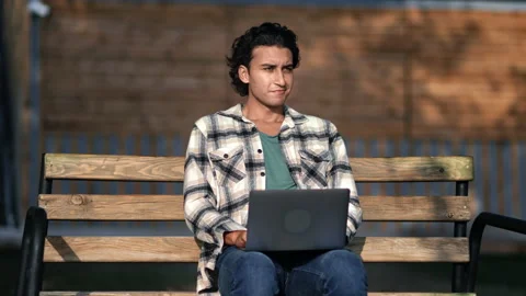 Smiling skilled Arabic male programmer developer freelancer working laptop on Stock-Footage 221013274