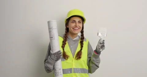 Smiling skilled female architect ready for repair dances carefree with positive Stock Footage 155859097