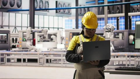 Smiling smart factory specialist testing automated systems to ensure reliability Stock Footage 307449932