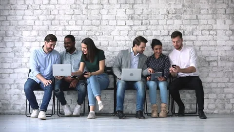 Smiling sociable applicants having fun, waiting for job interview. Stock Footage 131256765