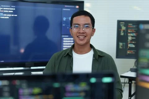 Smiling Software Developer in Artificial Intelligence Workspace Fotos Stock