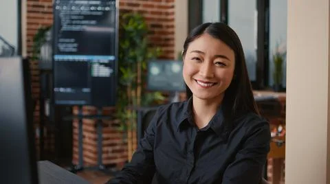 Smiling software developer typing machine learning app code on computer keyboard Stock Photos