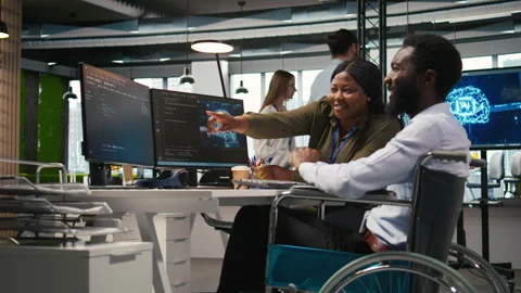 Smiling startup engineer and colleague with disability brainstorming, using AI Video stock 313015762