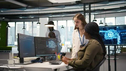 Smiling startup manager teaching junior dev how to use machine learning tech 写真素材