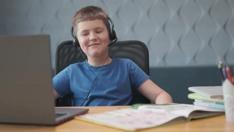Smiling student boy studying on the computer at remote school on the web Stock Footage 168355507