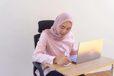 Smiling student learning online with her laptop Stock Photos