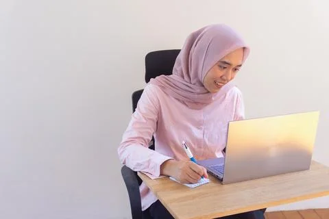 Smiling student learning online with her laptop Foto stock