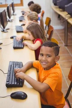 Smiling student using a computer Stock Photos