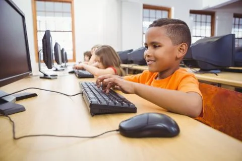 Smiling student using a computer Stock Photos