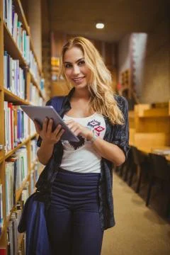 Smiling student using her tablet 스톡 사진