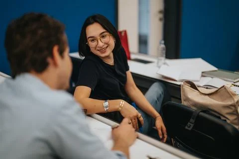 Smiling students interacting during a relaxed classroom session Stock Photos