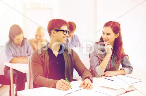 Smiling students with notebooks at school Stock Photos