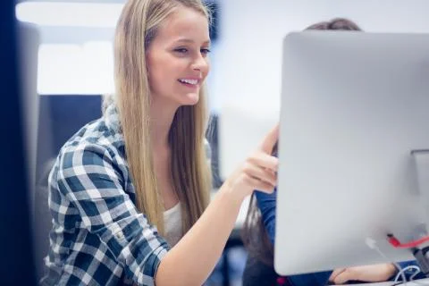 Smiling students using computer 스톡 사진