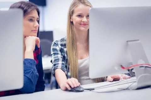 Smiling students using computer Stock Photos