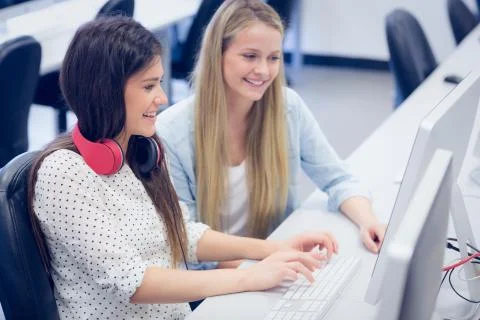 Smiling students using computer Foto stock